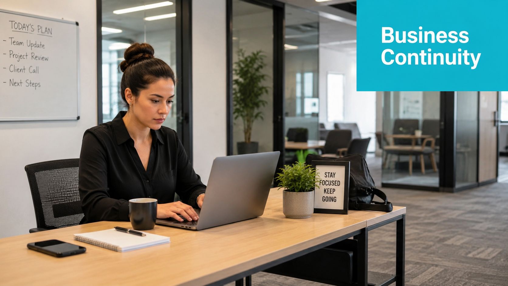 A professional woman working on her laptop at an office desk with business continuity text overlaid.