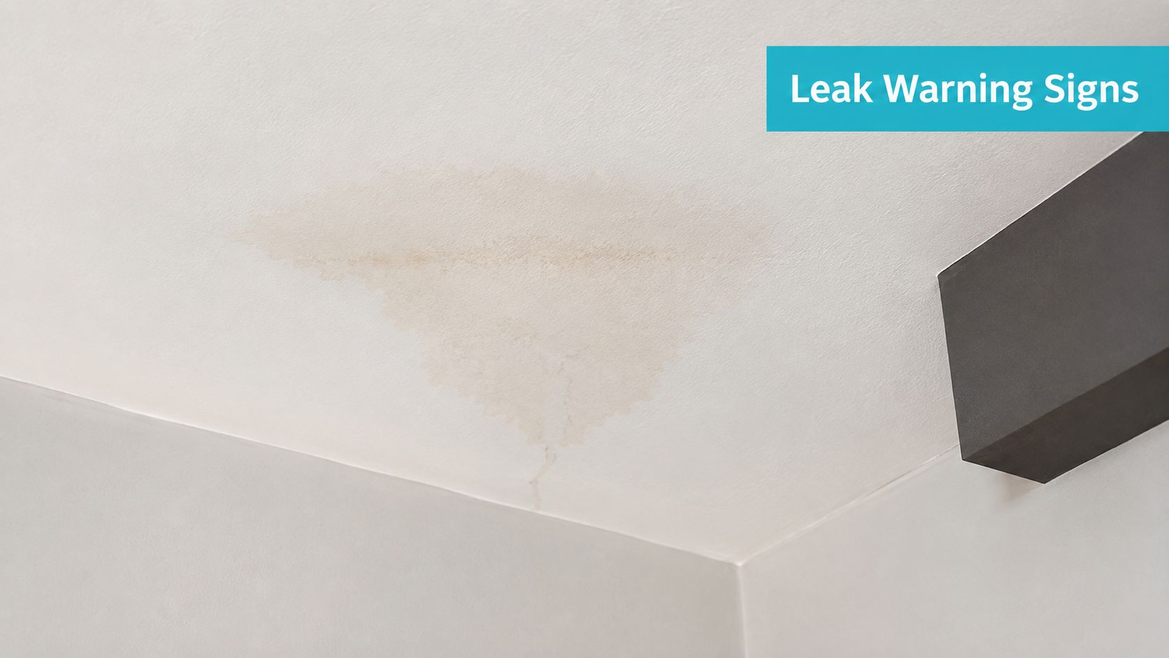 A water stain on a white ceiling indicating a potential leak and damage to the drywall.