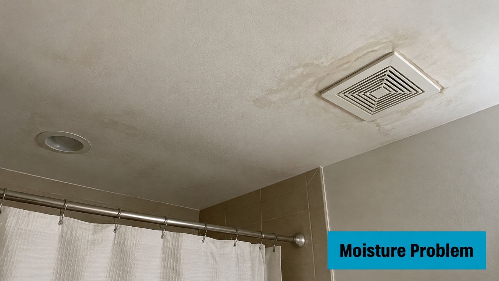 A bathroom ceiling showing water stains and potential mold growth around the ventilation fan and light.